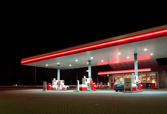 Gas station lit up at night.