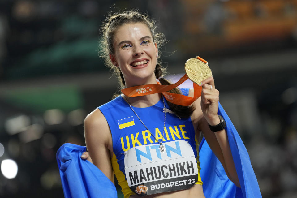 Yaroslava Mahuchikh, of Ukraine, poses after winning the gold medal in the Women's high jump final during the World Athletics Championships in Budapest, Hungary, Sunday, Aug. 27, 2023. (AP Photo/Matthias Schrader)