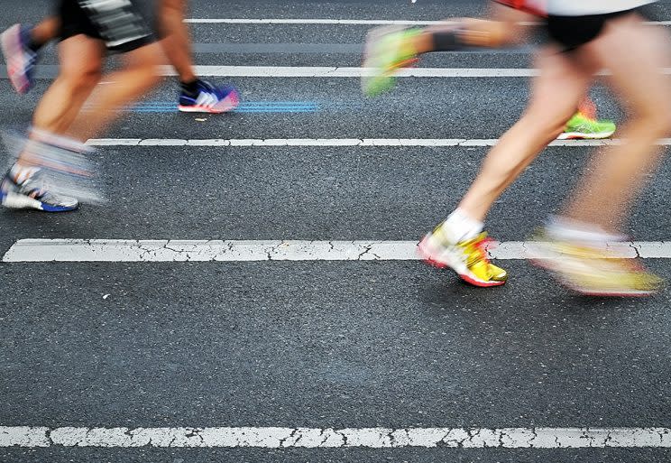 A father-son pair traded running shoes for Crocs in a recent half-marathon. (Photo: Getty Images)