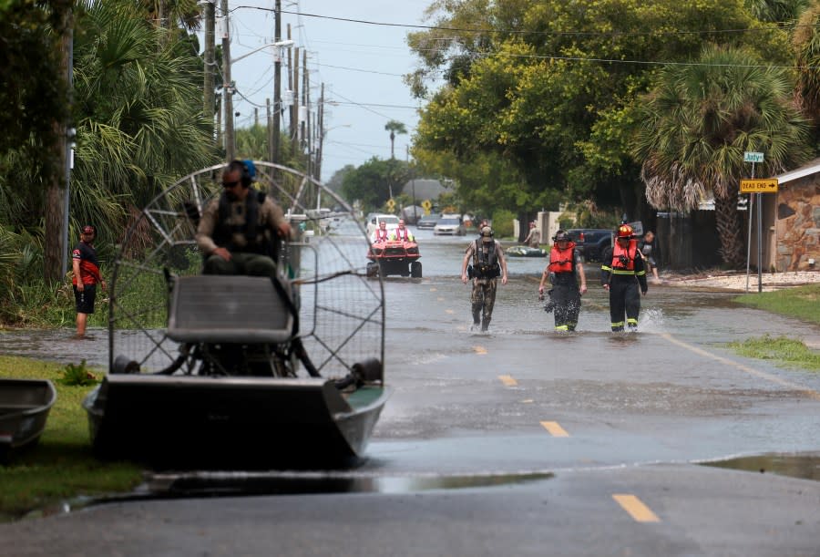 HUDSON, FLORIDA – AUGUST 30: Rescue personnel walk through a flooded street after Hurricane Idalia passed offshore on August 30, 2023 in Hudson, Florida. Hurricane Idalia hit the Big Bend area on the Gulf Coast of Florida as a Category 3 storm. (Photo by Joe Raedle/Getty Images)