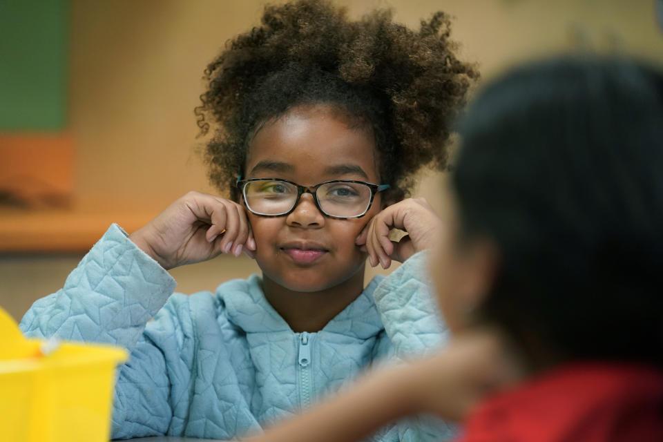 Nyakuma, no last name given, talks with a classmate during a Lean In session at Girls Inc., Wednesday, July 26, 2023, in Sioux City, Iowa. A new girls leadership program from Lean In, the organization launched after Sheryl Sandberg published her book, “Lean In: Women, Work and the Will to Lead,” will help girls respond to what Sandberg calls stubborn gender inequities. (AP Photo/Charlie Neibergall)