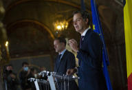 Belgian Minister of Cooperation Development and Finance, Alexander De Croo, right, and Belgian francophone Socialist Party chairman, Paul Magnette attend a media conference at the Egmont Palace in Brussels, Wednesday, Sept. 30, 2020. Almost 500 days after Belgian parliamentary elections, seven parties from both sides of the linguistic border have agreed on forming a fully functioning majority government that will center on dealing with the pandemic and its devastating economic impact. (AP Photo/Virginia Mayo)