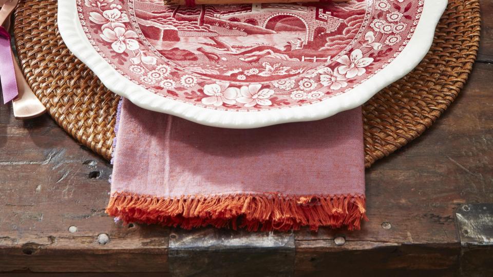 cinnamon stick place card on a red transferware plate