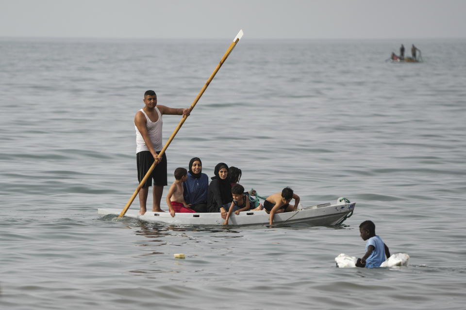 Palestinians spend the day on the beach along the Mediterranean Sea during a heatwave in Deir al Balah, Gaza Strip, Thursday, April 25, 2024. Over 80% of Gaza's population has been displaced by the ongoing war with Israel, and many have relocated to the area. Temperatures hovered near 37 degrees Celsius (100 degrees Fahrenheit). (AP Photo/Abdel Kareem Hana)