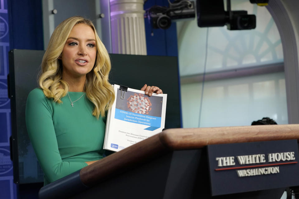 White House press secretary Kayleigh McEnany holds a coronavirus playbook speaks during a briefing at the White House in Washington, Friday, Nov. 20, 2020. McEnany suggested that the team for President-elect Joe Biden can use the coronavirus playbook. (AP Photo/Susan Walsh)