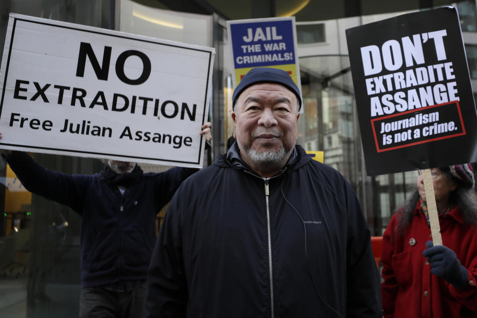 Chinese contemporary artist and activist Ai Weiwei stands with protesters outside the Old Bailey in support of Julian Assange's bid for freedom during his extradition hearing, in London, Monday, Sept. 28, 2020. (AP Photo/Kirsty Wigglesworth)