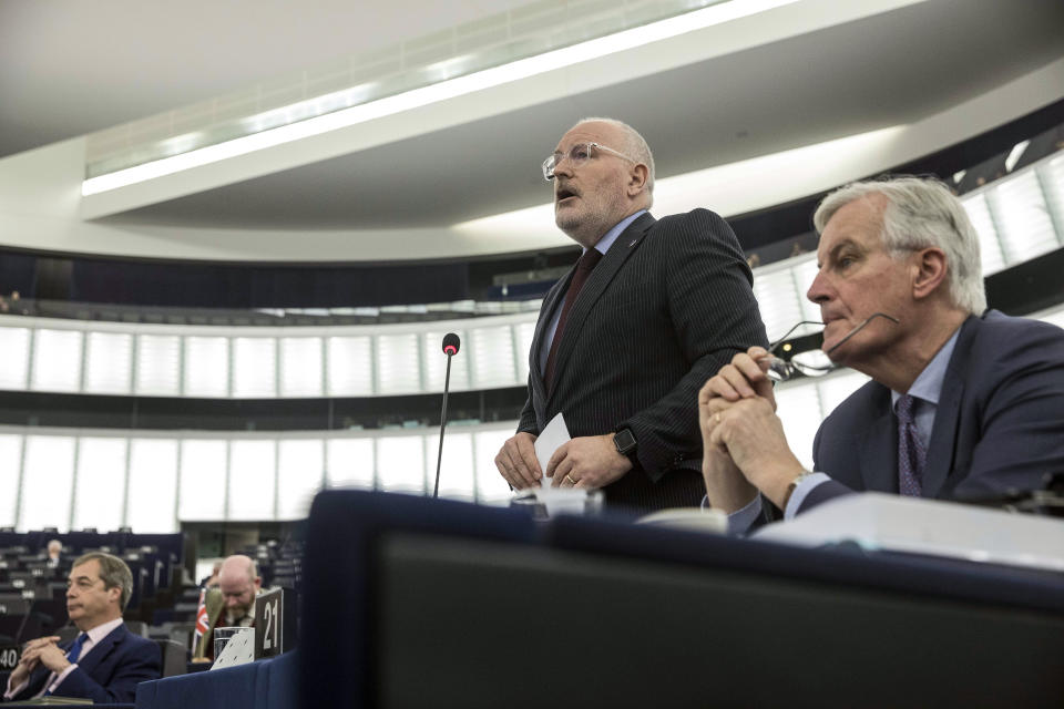 European Union's Frans Timmermans, first vice president of the Commission, center, delivers his speech with European Union's chief Brexit negotiator Michel Barnier, at right, and Former U.K. Independence Party (UKIP) leader and member of the European Parliament Nigel Farage, far left, during a session at the European Parliament in Strasbourg, eastern France, Wednesday, March 13, 2019. British lawmakers rejected May's Brexit deal in a 391-242 vote on Tuesday night. Parliament will vote Wednesday on whether to leave the EU without a deal. (AP Photo/Jean Francois Badias)