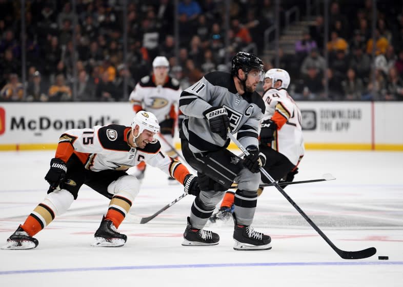 LOS ANGELES, CALIFORNIA - FEBRUARY 01: Anze Kopitar #11 of the Los Angeles Kings skates with the puck as he is chased by Ryan Getzlaf #15 of the Anaheim Ducks during the third period in a 3-1 Ducks win at Staples Center on February 01, 2020 in Los Angeles, California. (Photo by Harry How/Getty Images)