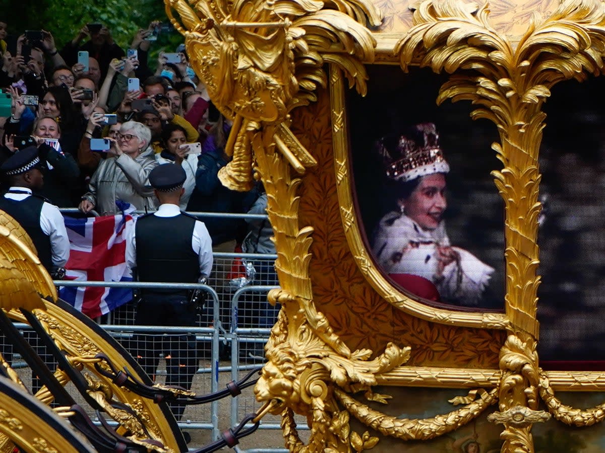  Flanked by guardsmen on horseback to complete the illusion, the CGI Queen was glimpsed enthusiastically gesturing to the crowds  (AFP via Getty Images)