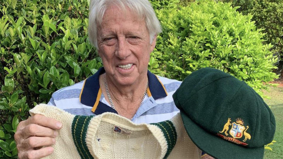 Jeff Thomson holding his baggy green and his vest, which he will sell to aid the bushfire relief appeal.