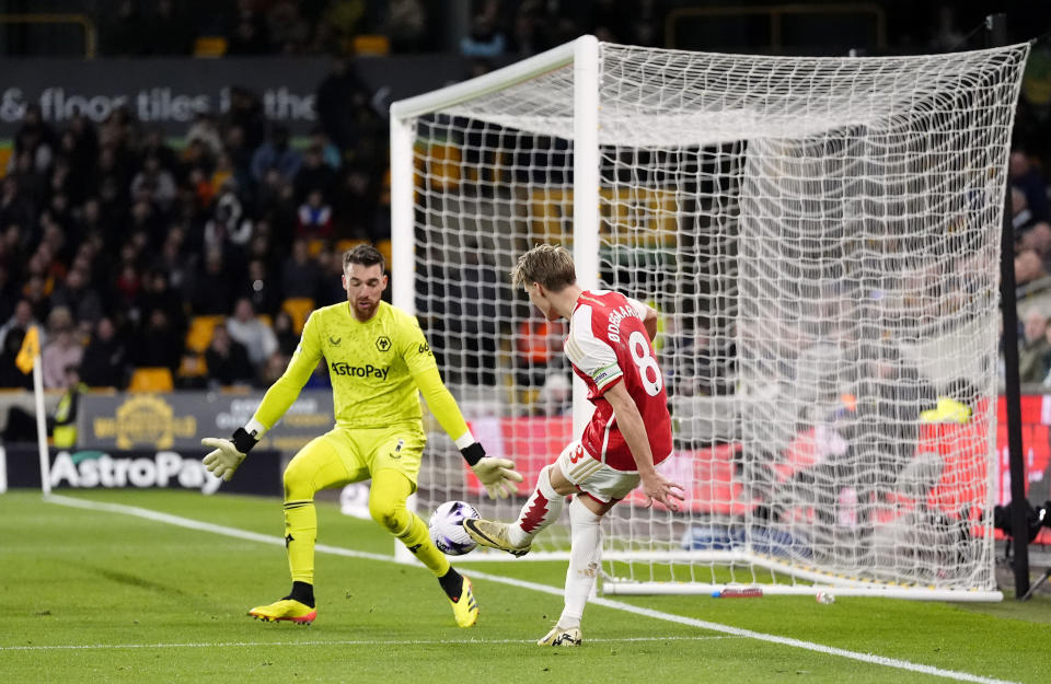 Arsenal's Martin Odegaard scores their side's second during the English Premier League soccer match between Wolverhampton Wanderers and Arsenal at the Molineux Stadium in Wolverhampton, England, Saturday, April 20, 2024. (Nick Potts/PA via AP)