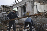 Rescue workers clear the rubble of a destroyed house after a Russian drone attack on a residential neighbourhood, in Zaporizhzhia, Ukraine, on Thursday, March 28, 2024. (AP Photo/Andriy Andriyenko)
