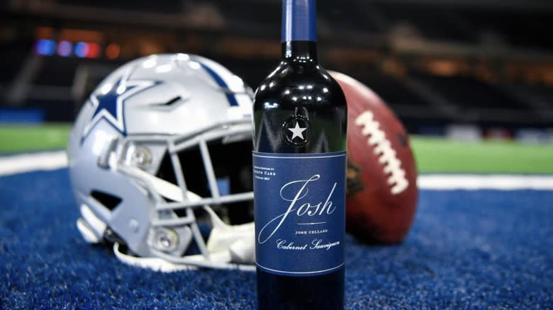 Bottle of wine with football equipment