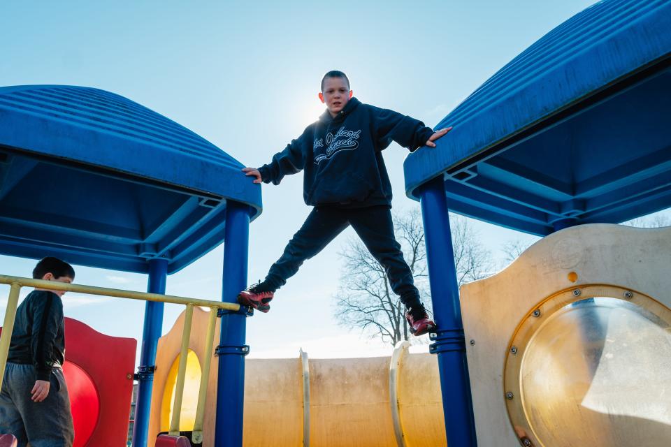 Colton Riel, 7, shows off his climbing skills on the playground at the Starlight School in New Philadelphia. The playground will be upgraded with rubberized mulch and the addition of sensory friendly play structures for kids with autism.