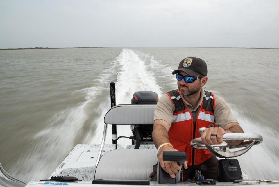Andy Stetter navigates the Intercostal Waterway on April 1, 2024, in Aransas County, Texas. The U.S. Fish and Wildlife wildlife biologist manages and monitors habitats at the Aransas National Wildlife Refuge.