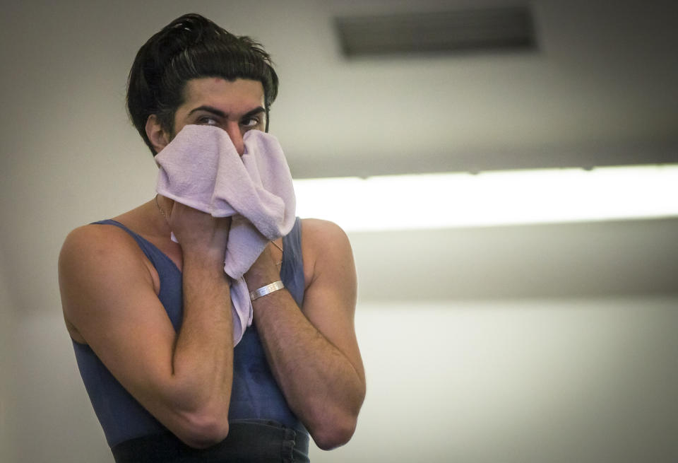 In this photo made Thursday, Feb. 14, 2013 Bolshoi ballet dancer Nikolai Tsiskaridze wipes the sweat as he holds a rehearsal in the Bolshoi Theater in Moscow, Russia. General director Anatoly Iksanov has accused principal dancer Nikolai Tsiskaridze of creating an atmosphere of intrigue that set the scene for the Jan. 17 acid attack on the Bolshoi’s artistic director. Tsiskaridze has rejected the claims and in turn pointed to the attack as evidence that the theater has descended into crime and violence on Iksanov’s watch. (AP Photo/Alexander Zemlianichenko)