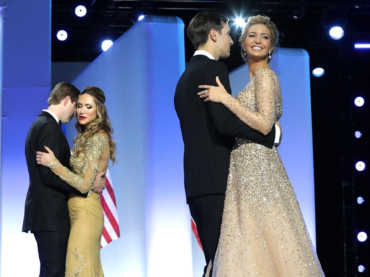 Ivanka Trump and Jared Kushner dance in the foreground and Eric and Lara Trump dance in the background at an inaugural ball