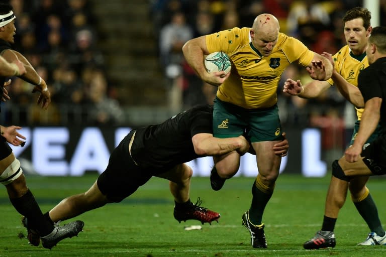 Australia's captain Stephen Moore (right) is tackled by New Zealand's Dane Coles during the rugby Test match between New Zealand and Australia at Westpac Stadium in Wellington on August 27, 2016