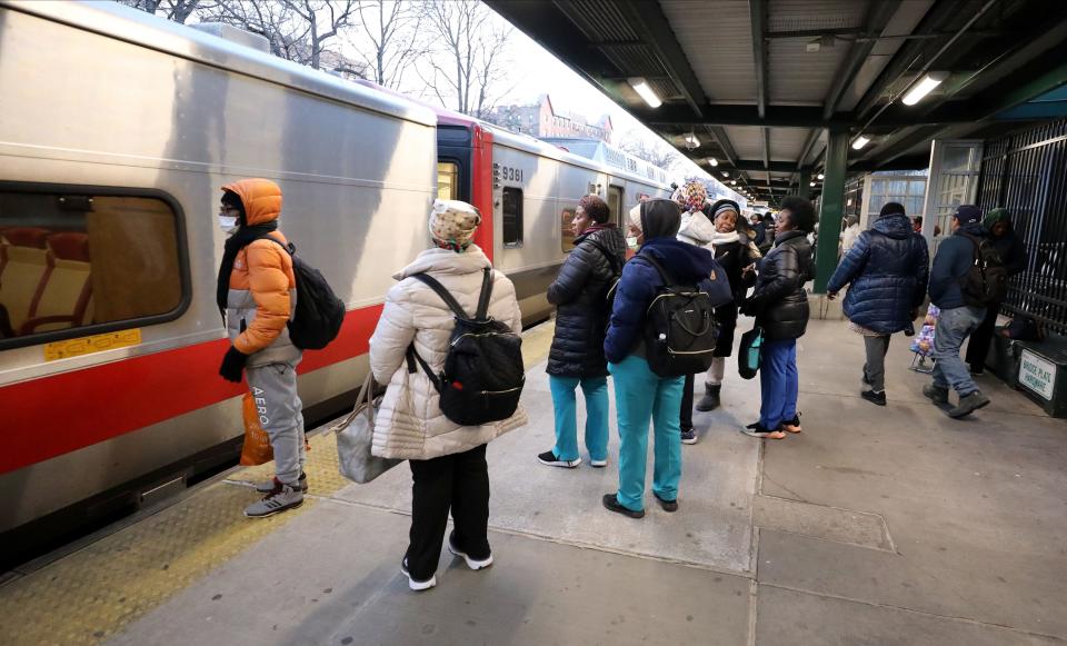 Health care workers in scrubs prepare to board a northbound Metro-North train from the Fordham Station in the Bronx, Feb. 8, 2024.