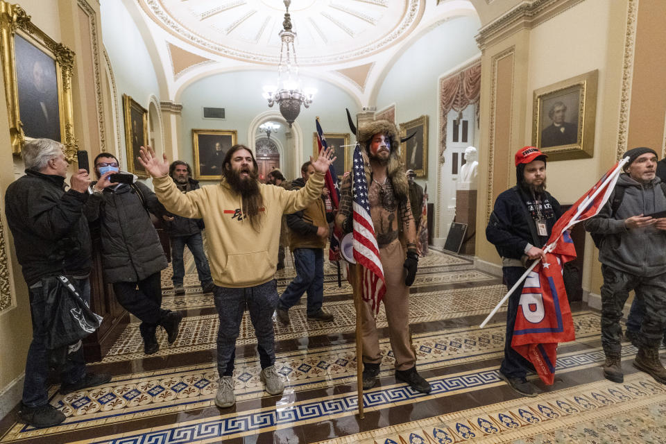 Supporters of President Donald Trump confront U.S. Capitol Police outside the Senate Chamber in the Capitol. At center is Jake Angeli, a regular at pro-Trump events and a known follower of QAnon.  (Photo: AP Photo/Manuel Balce Ceneta)