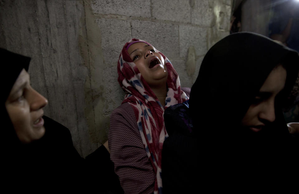 Palestinian relatives of 23 year-old Hamas fighter, Ahmad Morjan, mourn at the family home during his funeral, in the Jabaliya refugee camp, Northern Gaza Strip, Tuesday, Aug. 7, 2018. The Israeli military said it targeted a Hamas military post in northern Gaza after militants opened fire, and Hamas said two of its fighters were killed. (AP Photo/Khalil Hamra)