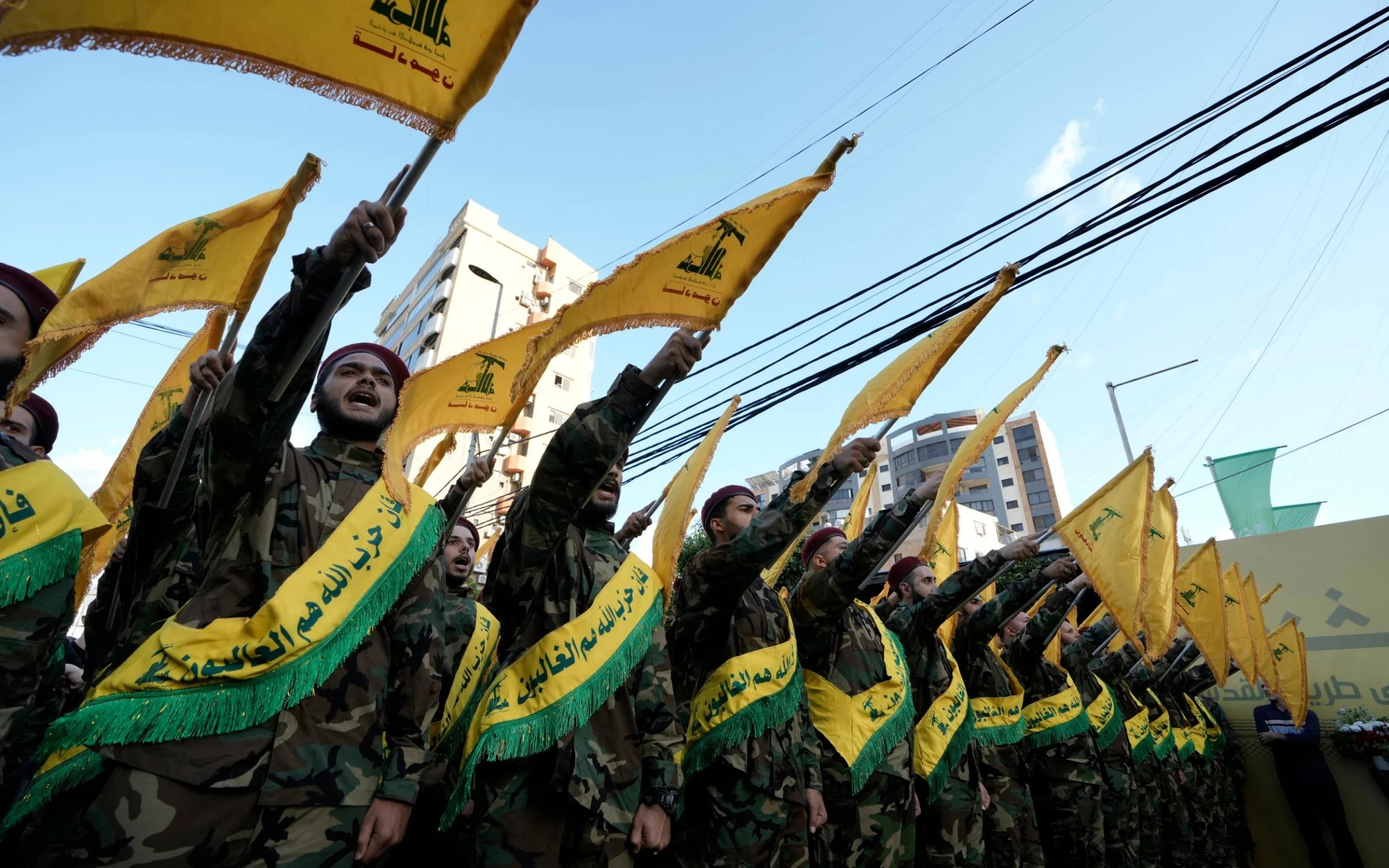 Hezbollah members march during the funeral procession of their comrades who were killed in Friday's Israeli strike