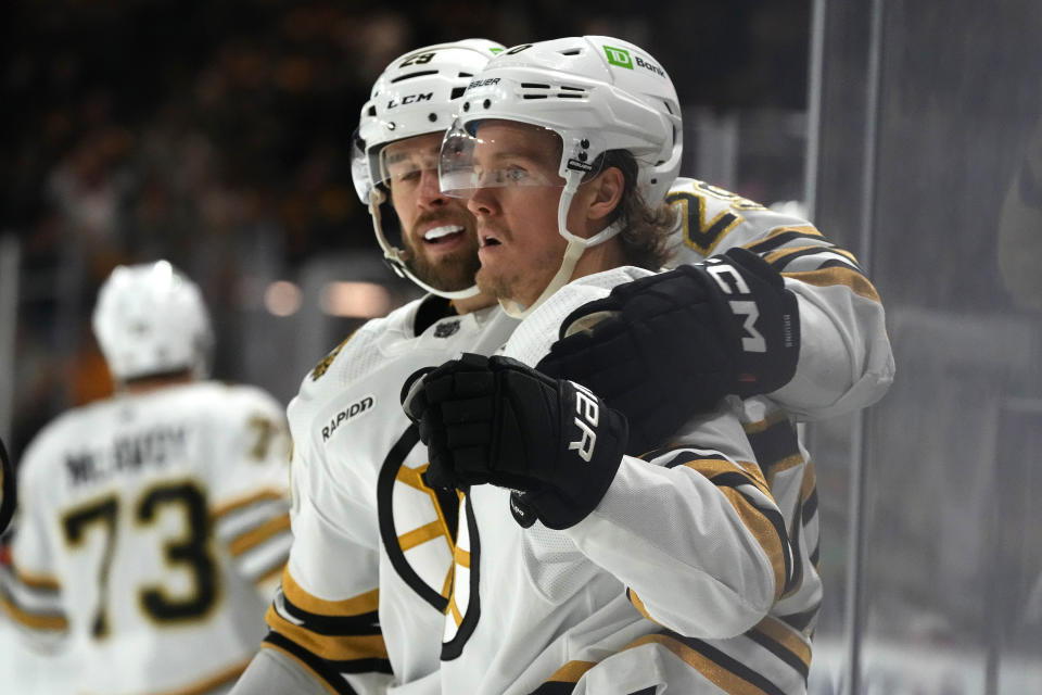 Boston Bruins center Jesper Boqvist, right, celebrates his goal against the Arizona Coyotes with Bruins defenseman Parker Wotherspoon (29) during the second period of an NHL hockey game Tuesday, Jan. 9, 2024, in Tempe, Ariz. (AP Photo/Ross D. Franklin)