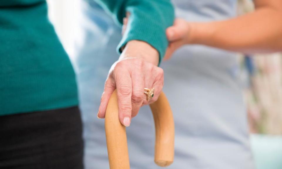 Female care worker helps elderly person