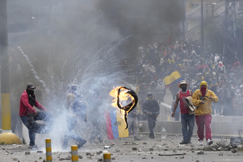 Demonstrators clash with police during protests against the government of President Guillermo Lasso and rising fuel prices, in Quito, Ecuador, Tuesday, June 21, 2022. Ecuador's defense minister warned Tuesday that the country's democracy was at risk as demonstrations turned increasingly violent in the capital. (AP Photo/Dolores Ochoa)