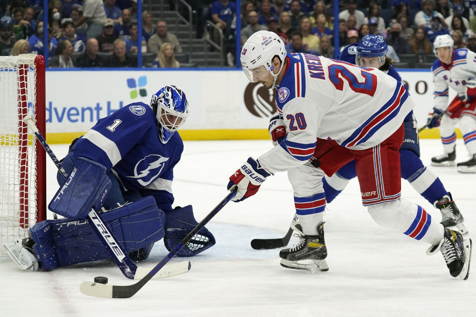 Tampa Bay Lightning goaltender Brian Elliott (1) makes a save on a shot by New York Rangers left wing Chris Kreider (20) during the first period of an NHL hockey game Friday, Dec. 31, 2021, in Tampa, Fla. (AP Photo/Chris O'Meara)