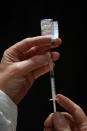 FILE -In this Thursday, Jan. 28, 2021 file photo, a member of the medical staff prepares a syringe with the Moderna COVID-19 vaccine at a vaccination center in Schiltigheim, eastern France. As soon as it dawned on the continent more than one year ago that the virus would turn into the worst pandemic in a century, the race for a vaccine was on. In securing one, once it was available, the EU could not be as nimble as such a crisis situation demanded. The EU nations got competitive prices, but it took valuable time. (AP Photo/Jean-Francois Badias, File)