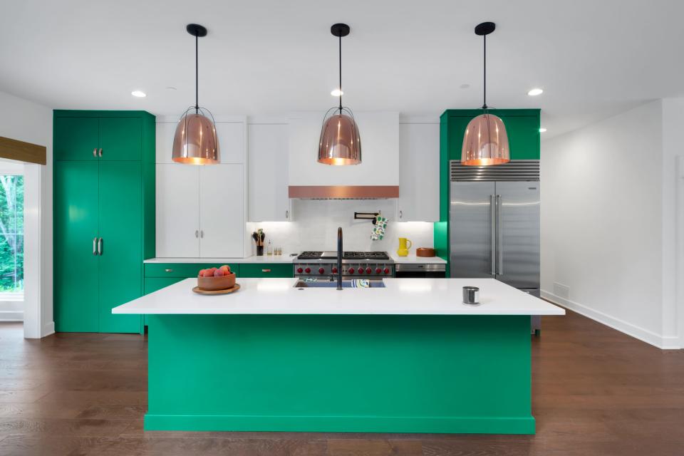Kelly green and copper make the kitchen pop in this modern farmhouse-style home built by the Eldridge Company in Louisville.