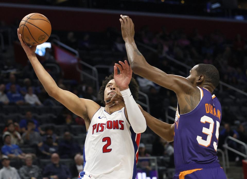 Detroit Pistons guard Cade Cunningham (2) goes to the basket against Phoenix Suns forward Kevin Durant (35) during the first half of a preseason NBA basketball game Sunday, Oct. 8, 2023, in Detroit. (AP Photo/Duane Burleson)