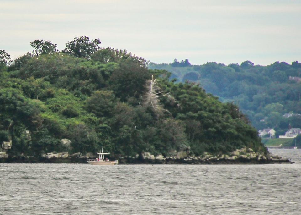 A boat passes near the edge of Gould Island in the Sakonnet River, near Tiverton.