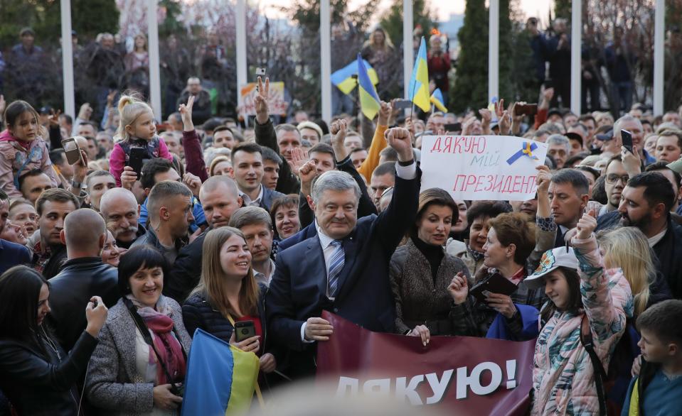 Ukrainian President Petro Poroshenko poses for a photo with his supporters who have come to thank him for what he did as a president, in Kiev, Ukraine, Monday, April 22, 2019. Political mandates don't get much more powerful than the one Ukrainian voters gave comedian Volodymyr Zelenskiy, who as president-elect faces daunting challenges along with an overwhelming directive to produce change. (AP Photo/Vadim Ghirda)