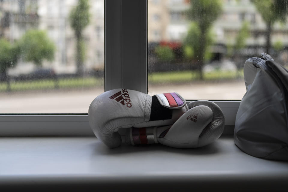 Ukrainian boxer Anna Lysenko's boxing gloves rest on a window sill during her training at Kiko Boxing Club in Kyiv, Ukraine, Tuesday, July 11, 2023. Lysenko dedicates long hours preparing for next year's Paris Olympics despite the unsettling sounds of explosions booming outside. (AP Photo/Jae C. Hong)