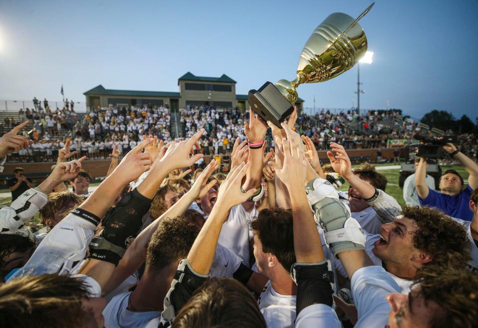 St. X celebrates their state championship trophy after defeating South Oldham in Monday night's state lacrosse championship game. May 22, 2023.