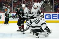 Arizona Coyotes' Jakob Chychrun, not seen, gets the puck past Los Angeles Kings goaltender Calvin Petersen (40) for a goal as Coyotes left wing Michael Bunting (58), Kings defenseman Mikey Anderson (44) and Kings defenseman Drew Doughty (8) watch during the first period of an NHL hockey game Wednesday, May 5, 2021, in Glendale, Ariz. (AP Photo/Ross D. Franklin)