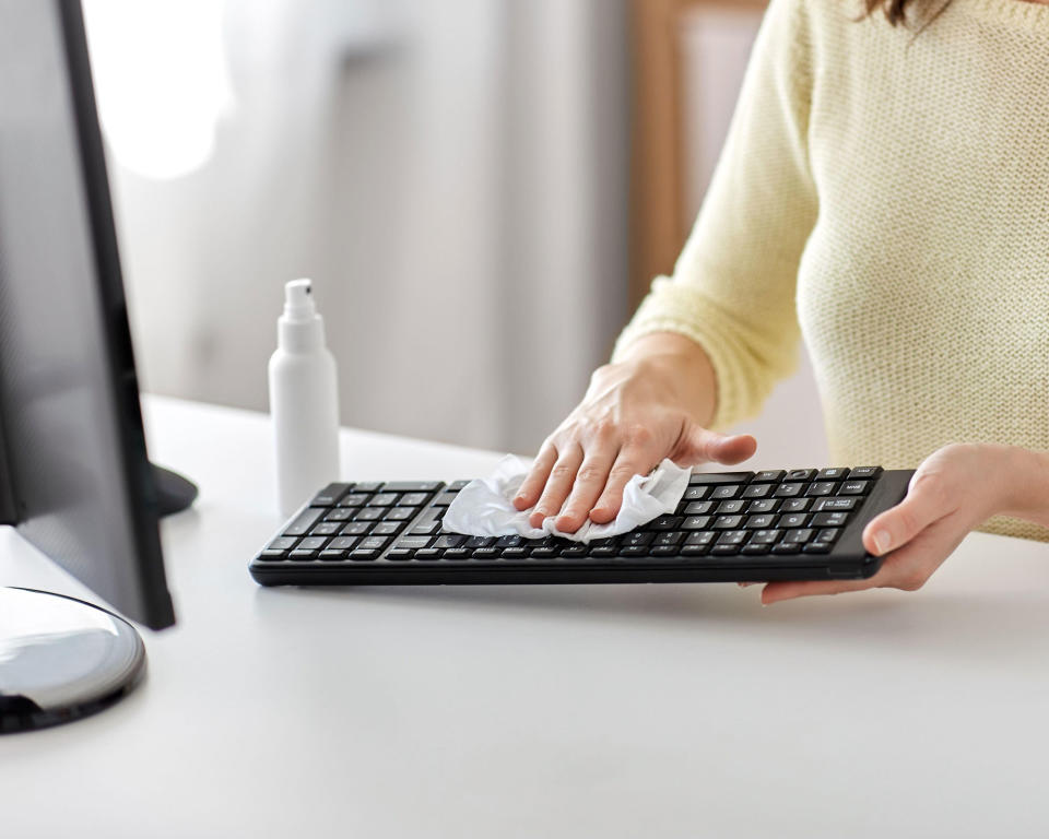 cleaning a computer keyboard with a damp cloth