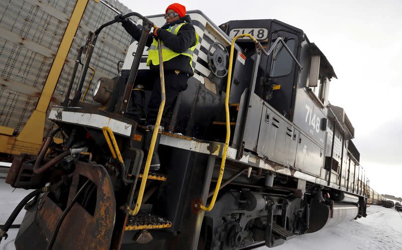 Woman steps off a train during her conductor trainee program at Norfolk Southern's Calumet Yard in Chicago