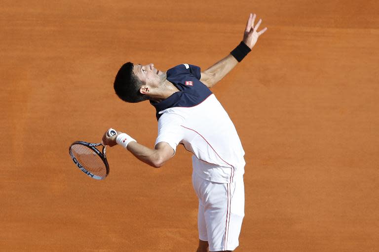 Serbia's Novak Djokovic serves to Spain's Pablo Carreno Busta during their Monte-Carlo ATP Masters Series Tournament tennis match, on April 17, 2014 in Monaco