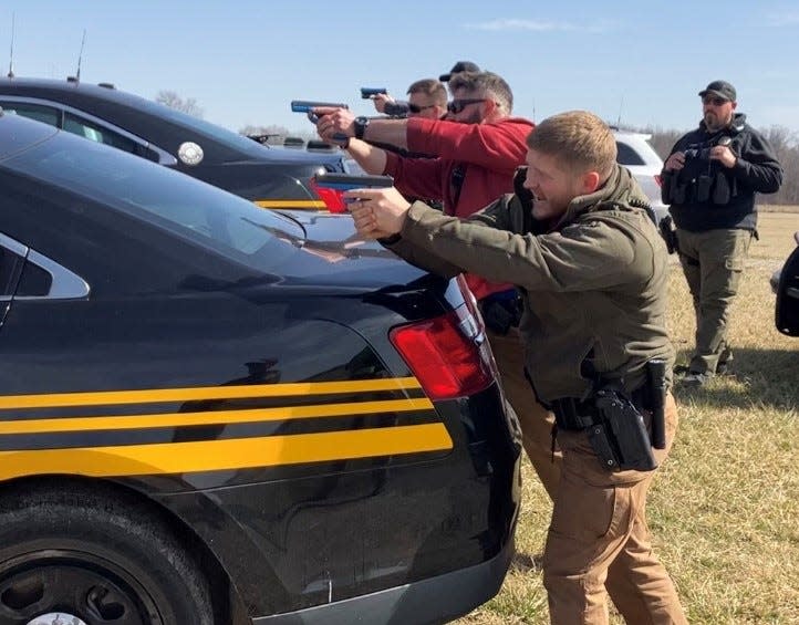 Newark Police Department, Licking County Sheriff's Office and the State Highway Patrol participate in a rare joint training operation Wednesday at the Hartford Fairgrounds in Croton. On the right with gun drawn is Brad Ellis of Newark Police. Next to him in the red sweatshirt is NPD's Kevin Fairfield.