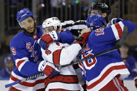 New York Rangers defenseman K'Andre Miller (79) pulls Carolina Hurricanes center Vincent Trocheck (16) off Rangers center Ryan Strome (16) in the first period of Game 3 of an NHL hockey Stanley Cup second-round playoff series, Sunday, May 22, 2022, in New York. (AP Photo/Adam Hunger)