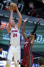 Detroit Pistons center Mason Plumlee (24) shoots over Miami Heat guard Gabe Vincent (2) during the second half of an NBA basketball game, Saturday, Jan. 16, 2021, in Miami. (AP Photo/Lynne Sladky)