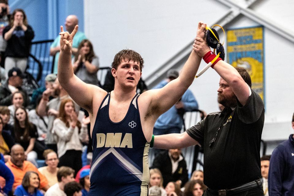 Delaware Military Academy sophomore Cael DeNigris gets his hand raised after his 1st place win over St. Elizabeth senior Stephen Goodman during the 285 pounds championship finals of the DIAA Individual Wrestling State Tournament at Cape Henlopen High in Lewes, Saturday, March 4, 2023.