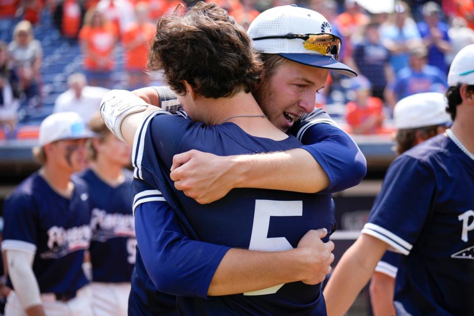 Olentangy Orange's Jacob Tabor hugs Charlie Scholvin (5) after the Pioneers' 4-1 loss to Cincinnati Moeller in the Division I state final.