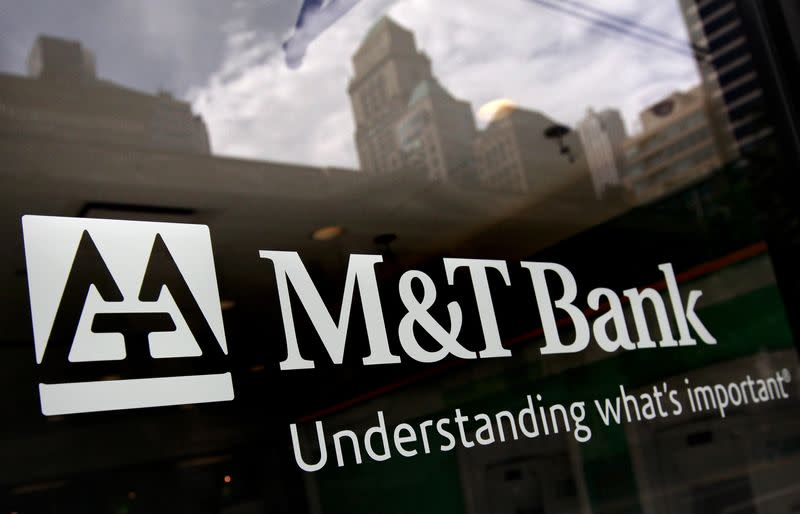 Buildings are reflected in the window of an M&T Bank branch in New York