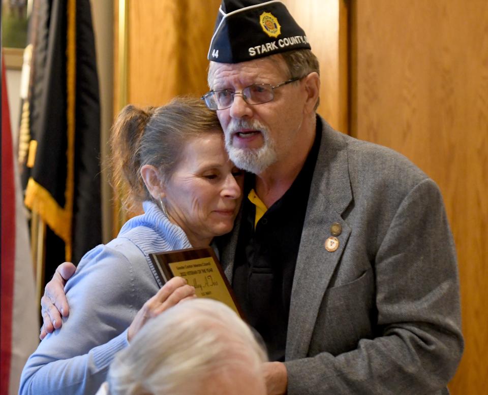 John Ley, commander of the American Legion of Stark County, hugs Roxanne Teis, who received an honor for her late husband, Bradley Teis. He was recognized posthumously as 2022 Veteran of the Year. The honor was presented by the Greater Canton Veterans Service Council at a Veterans Day ceremony at American Legion Post 44 in Canton.