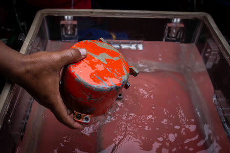 A member of Indonesia's Navy Kopaska holds a cockpit voice recorder (CVR) of a Lion Air JT610 that crashed into Tanjung Karawang sea, on the deck of Indonesia's Navy ship KRI Spica-934 at Karawang sea in West Java, Indonesia, January 14, 2019 in this photo taken by Antara Foto. Antara Foto/Aprillio Akbar/ via REUTERS