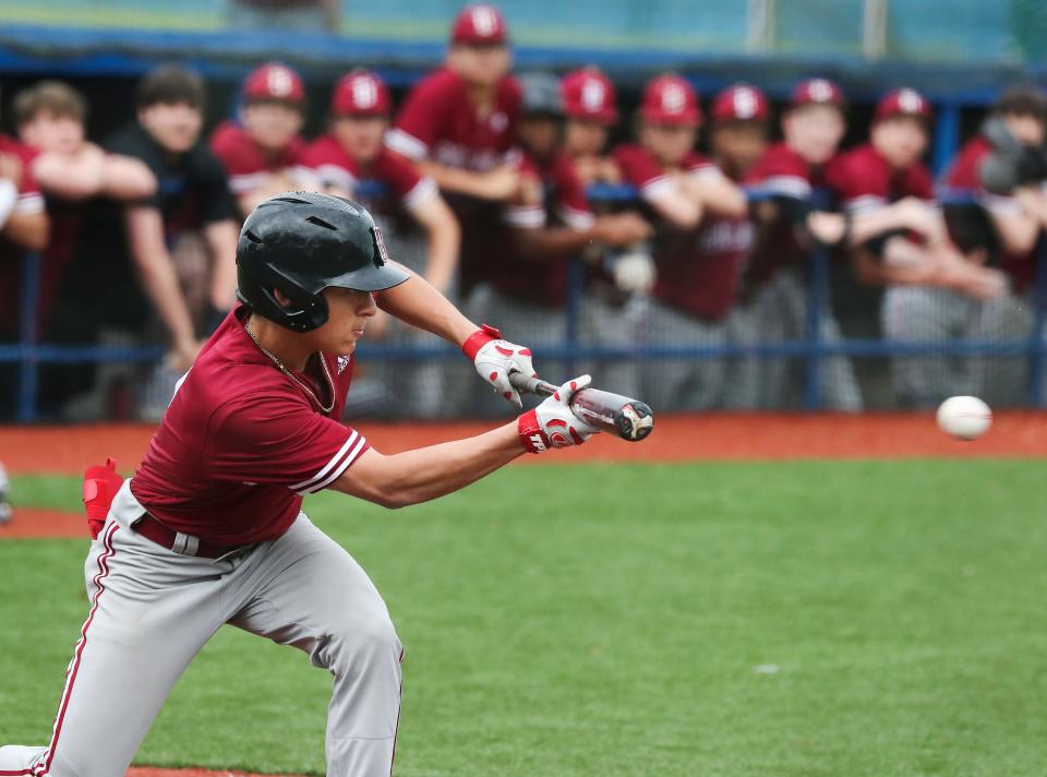 Ballard's Sam Bevin (7) hits a bunt single to load the bases against Eastern during the district semifinal at the Kentucky Country Day field in Louisville, Ky. on May 18, 2022.  Ballard cruised to a 12-1 victory.